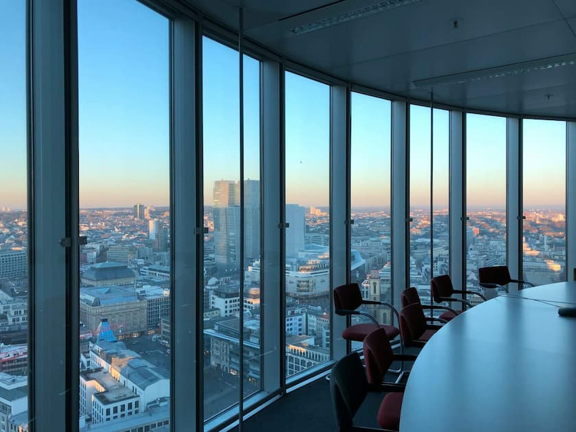 Empty boardroom with view of city from corner window